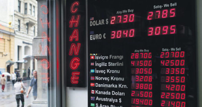People walk past a currency exchange office in Istanbul, Turkey, Monday, June 8, 2015. The Turkish currency on Monday dropped to a record low against the dollar over the political uncertainty, trading at 2.8 lira against the dollar. On elections held Sunday, June 7, 2015, Turkey’s long-ruling party has suffered surprisingly strong losses in parliament that will force it to seek a coalition partner for the next government, but other parties vowed to resist any pact as election results flowed in Monday. President Recep Tayyip Erdogan
